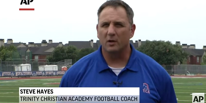 Trinity Christian Academy coach on a football field.